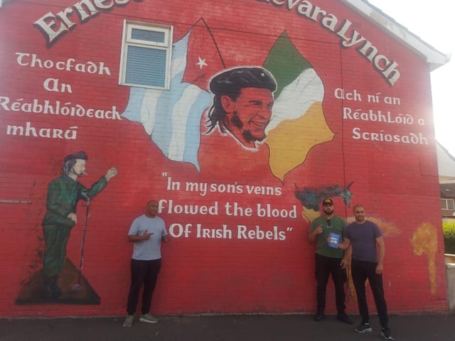 Mr. Dennis with friends at the Che Guevara mural in the Bogside.