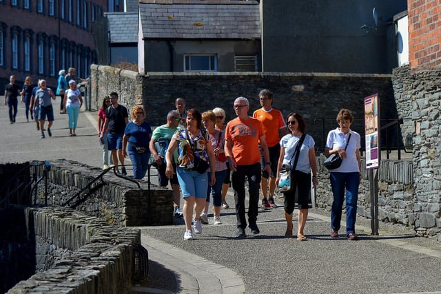 Visitors enjoy the sunshine and a walk on Derry’s historic Walls yesterday afternoon.  Photo: George Sweeney.  DER2232GS – 023