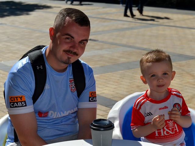 Fiachra Carton and his dad Kyle enjoy the hot weather in Derry yesterday afternoon. Photo: George Sweeney. DER2232GS – 024