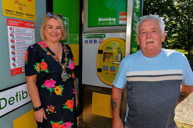 Mayor Sandra Duffy and Martin McCartney, chair of Maydown Community Association pictured at the launch of a Defibrillator in the old telephone box at Maydown housing yesterday morning. Photo: George Sweeney.  DER2232GS – 018