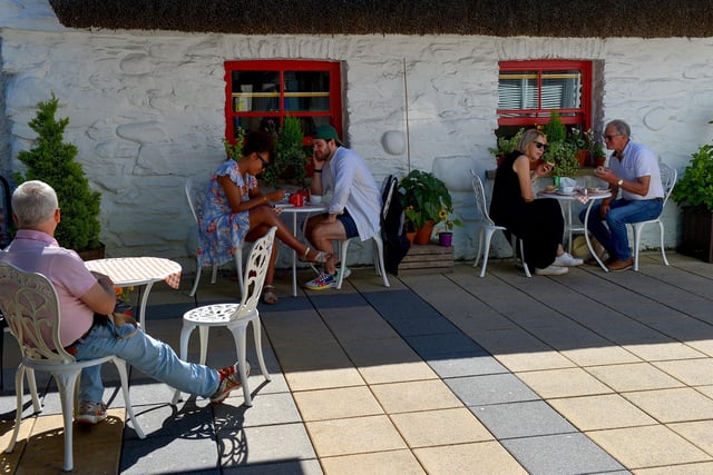 Enjoying the hot spell and an al fresco lunch in the Craft Village, yesterday afternoon.  Photo: George Sweeney.  DER2232GS – 026