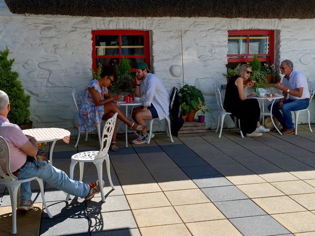 Enjoying the hot spell and an al fresco lunch in the Craft Village, yesterday afternoon. Photo: George Sweeney. DER2232GS – 026