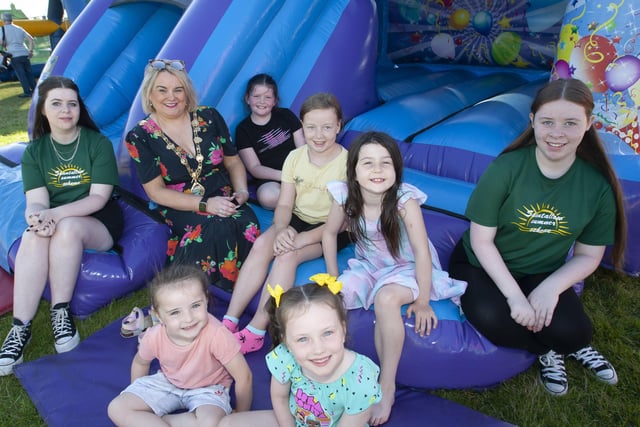 Community Summer Scheme volunteers and sisters Cara and Nicola Donegal pictured with the Mayor Sandra Duffy and some of the youngsters enjoying Thursdayâ€TMs â€ ̃Party in the Parkâ€TM, in Shantallow.