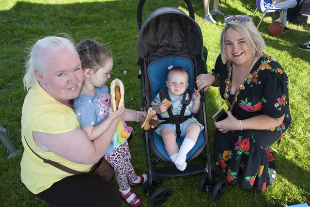 ENJOYING HIS BURGER!. . . . Mayor Sandra Duffy pictured with Regina Farren and Anna (4) and Oisin (1) during the Shantallow 'Party in the Park' on Thursday.