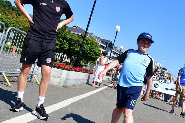 Derry City player Ciaron Harkin keeping Niall company on his walk.