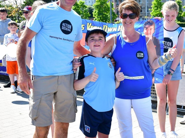 Niall with proud parents Kevin and Deborah O'Doherty at the finish line.