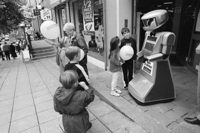 Young people meet Cosmo the robot at the ShopElectric 30th birthday party in Shipquay Street