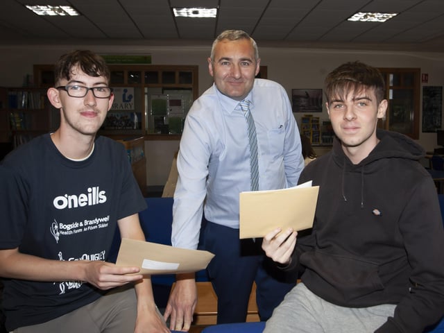 Senior Teacher Mr. Gerry Beattie pictured with A Level students Shea Gallagher and Adam Gallagher after they picked up their results on Thursday morning.
