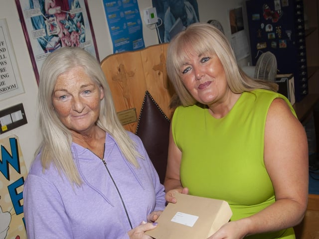 Mrs. Ciara Deane, Principal Designate, St. Josephâ€TMs Boys School handing over Tiernan Oâ€TMNeillâ€TMs A Level results to his mum Cathy.