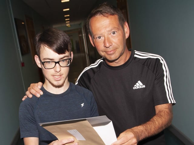 Evan McGahey is congratulated by his dad after getting his results at St. Josephâ€TMs Boys School on Thursday morning.