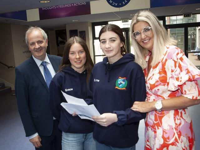 Oakgrove A Level students Grace Donaghy and Suranne Mullan show their results to Mr. John Harkin, Principal Designate and Mrs. Katrina Crilly, Principal.