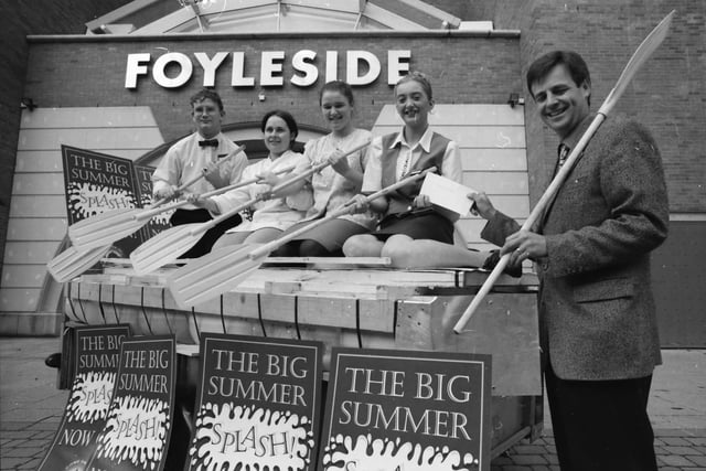 Des Farrell, manager, Foyleside Shopping Centre, presenting members of the Kylemore Cafe raft race team with a
