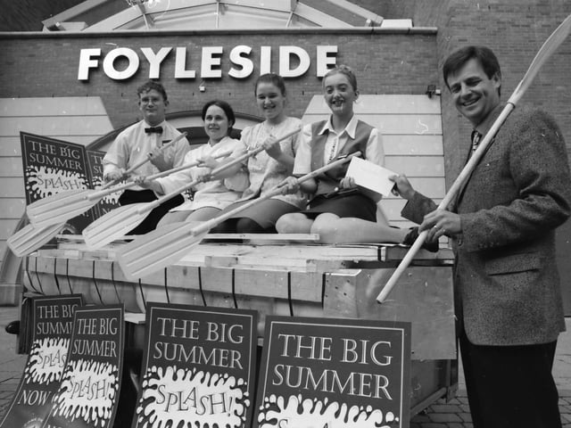 Des Farrell, manager, Foyleside Shopping Centre, presenting members of the Kylemore Cafe raft race team with a