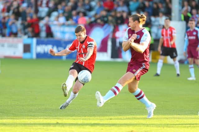 Derry City's Patrick McEleney sees his curling strike around Drogheda United's Keith Cowan flash just wide.