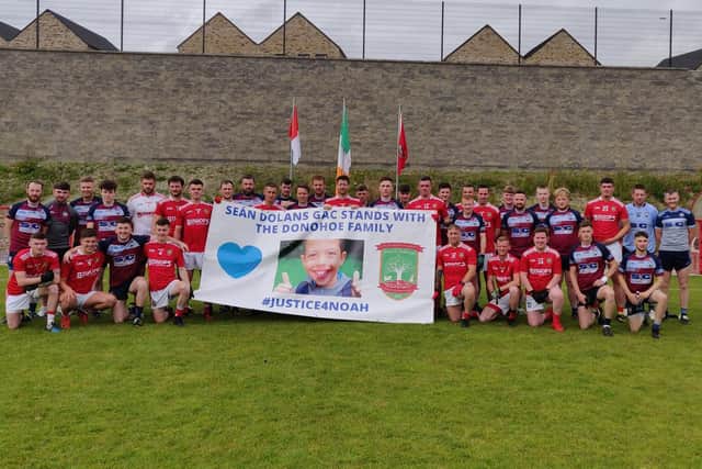 players from Sean Dolan's and Glack show their support for the family of Noah Donohoe prior to Sunday's Derry Junior Football Championship match at Piggery Ridge in Creggan.