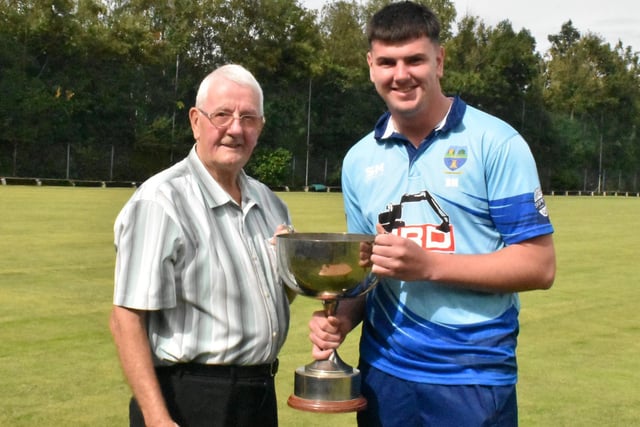 Davy Caldwell of the Derry Midweek League presents the Sperrin Springs Cup to Glendermott captain, Ben Mills.