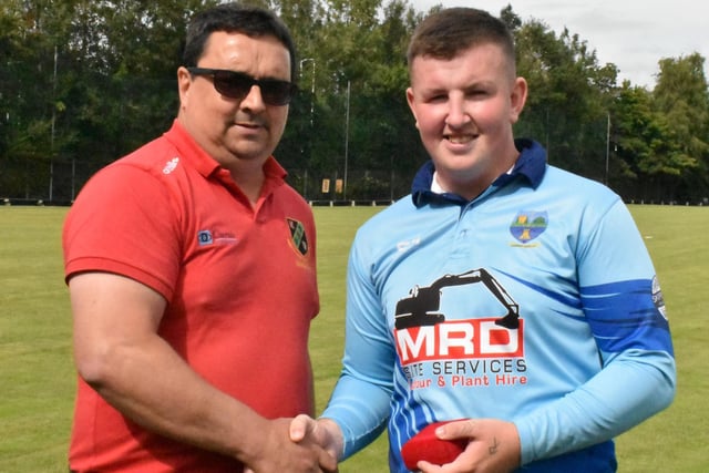 Nathan McGuire (Glendermott) receives his man-of-the-match award from Umpire, Norman Allen.