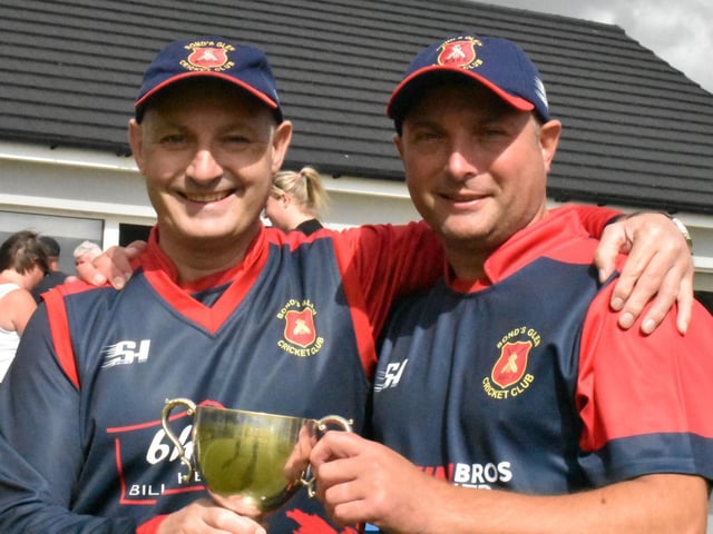Bonds Glen brothers David and Gordon Cooke hold the Championship trophy.