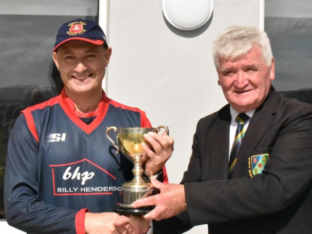 North West President Connie McAllister presents the Championship trophy to David Cooke, Bonds Glen captain.
