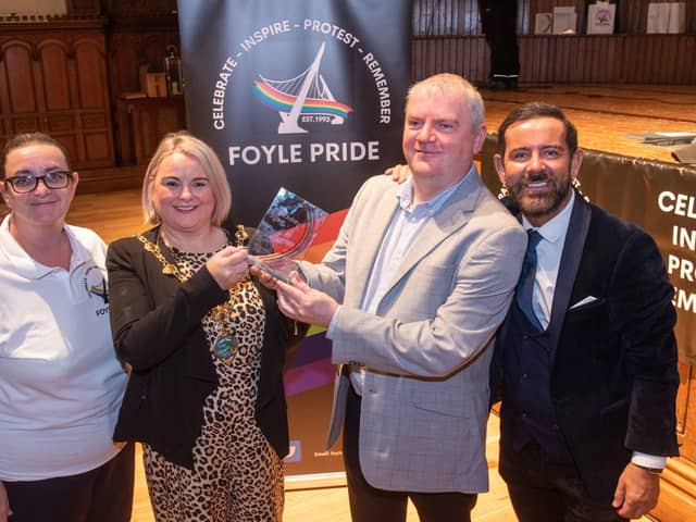 Derry City and Strabane District Council Mayor, Councillor Sandra Duffy presents the Mark Ashton Award for Outstanding Contribution to the LGBTQ+ Community to Martin McConnell-Logue during the Foyle Pride Awards in the Guildhall. Included are Kathleen Bradley, Chair of Foyle Pride and Michael Doherty who compered the event. Picture Martin McKeown. 22.08.22
