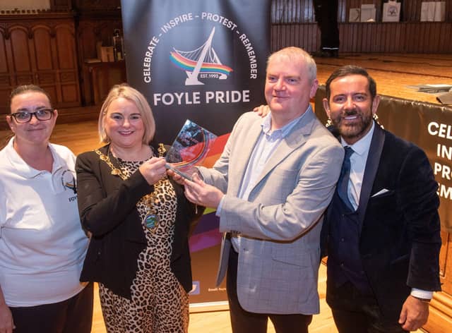 Derry City and Strabane District Council Mayor, Councillor Sandra Duffy presents the Mark Ashton Award for Outstanding Contribution to the LGBTQ+ Community to Martin McConnell-Logue during the Foyle Pride Awards in the Guildhall. Included are Kathleen Bradley, Chair of Foyle Pride and Michael Doherty who compered the event. Picture Martin McKeown. 22.08.22