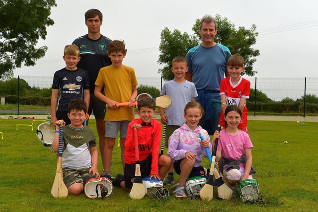 Gaelic games coaches Paddy O’Kane, Faughanvale and Gerry Matthews, Na Magha, pictured with children who attended the Eglinton Community Summer Scheme.