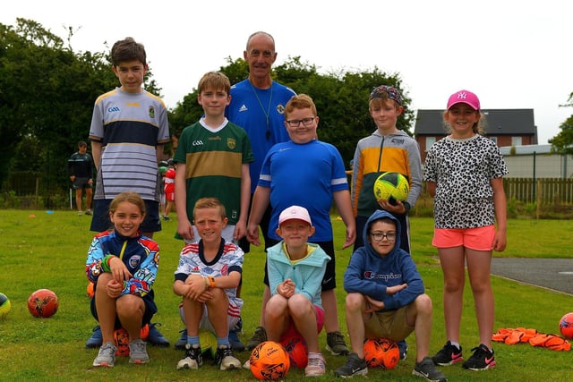 Children at the Eglinton Community Summer Scheme pictured with soccer coach Geoff Ferris.