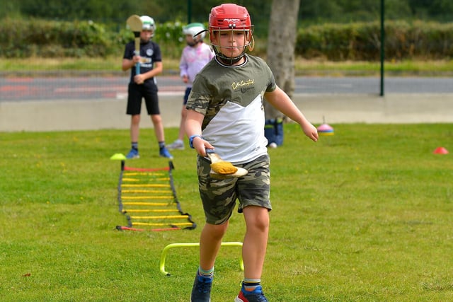 Practicing hurling skills at the Eglinton Community Summer Scheme, which took place at Broadbridge Primary School..