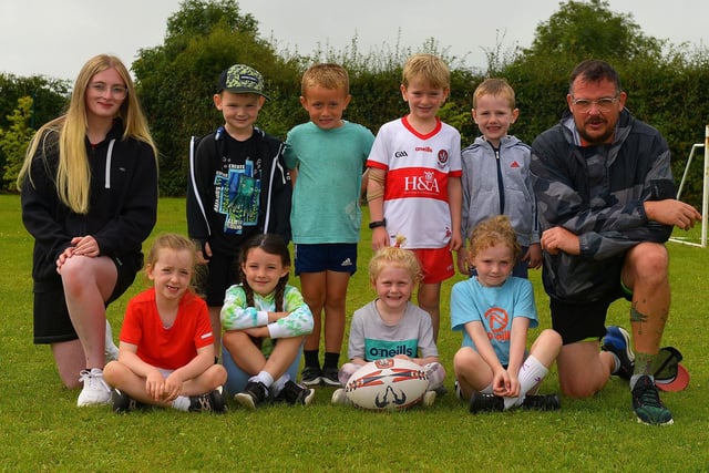 Rugby coaches Niamh Logue and Gary McDaid pictured with some of the children who attended the Eglinton Community Summer Scheme.
