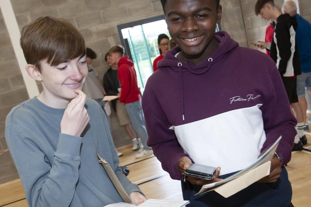 Phoning home to confirm GCSE results are St. Columbâ€TMs students Tony Bradley and John Akhionbare.