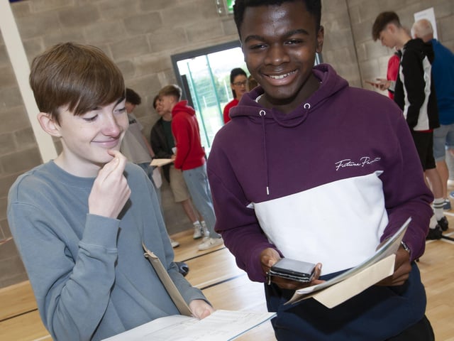 Phoning home to confirm GCSE results are St. Columbâ€TMs students Tony Bradley and John Akhionbare.