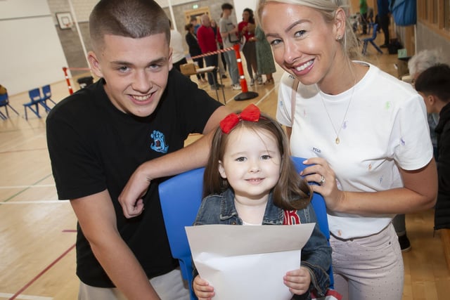 BIG BROTHER DID WELL!. . . .Little Penny Bradley (3) checks out big brother Davinâ€TMs GCSE results at St. Columbâ€TMs College on Thursday morning. Included is mum Emma.