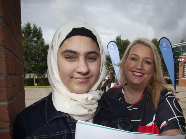Roisin Rice, Vice Principal, St Maryâ€TMs College congratulating one of the schoolâ€TMs GCSE students on Thursday morning.