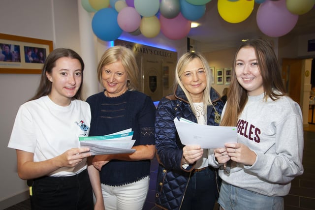 Catherine Ward and her mum Geraldine and Evie Coyle and her mum Maureen check over their results at St. Maryâ€TMs College.