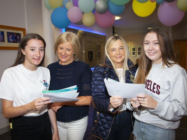 Catherine Ward and her mum Geraldine and Evie Coyle and her mum Maureen check over their results at St. Maryâ€TMs College.