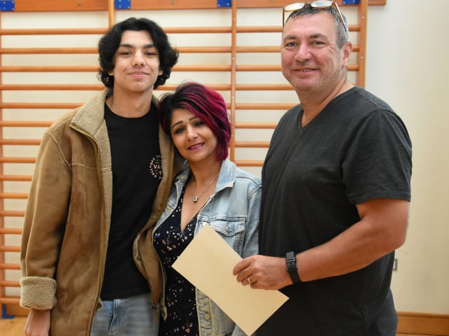 GCSE student Lukas Lynch pictured with his parents Sangita and James at Oakgrove Integrated College on Thursday morning.