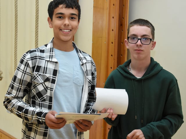 Omar Musa and Leo Arbuckle pick up their GCSE results at Oakgrove Integrated College on Thursday morning.