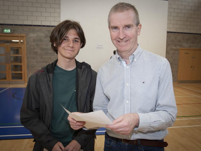 Principal of St. Columbâ€TMs College Mr. Finbar Madden congratulates Callum Webb on his GCSE results on Thursday morning. Callum for 8A*s and 2As. (Photos: Jim McCafferty Photography)