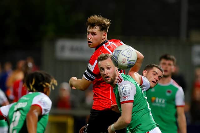 Derry City's Cameron McJannet heads away from Cork City's Kevin O'Connor.