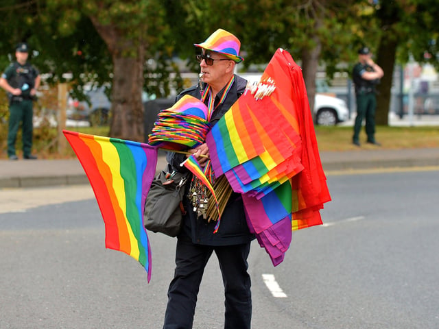 Vendor with flags and hats for sale at the Foyle Pride Parade in Derry on Saturday afternoon. Photograph: George Sweeney / Derry Journal. DER2234GS – 027