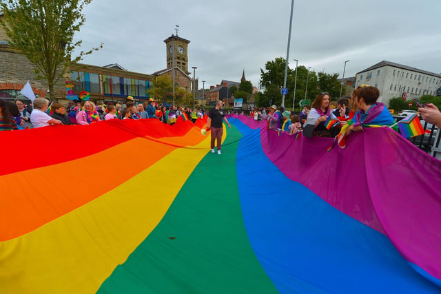 Preparing the rainbow flag for the Foyle Pride Parade in Derry on Saturday afternoon. Photograph: George Sweeney / Derry Journal. DER2234GS – 025