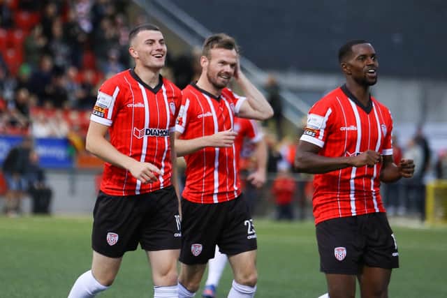 Ryan Graydon celebrates his fifth minute goal against UCD with Derry City teammates Cameron Dummigan and Sadou Diallo.