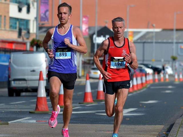 Third placed Scott Rankin, Foyle Valley, City of Derry Spartans’ Declan Reed, who finished second, make their way along the Foyle Embankment. Photo: George Sweeney. DER2236GS – 019