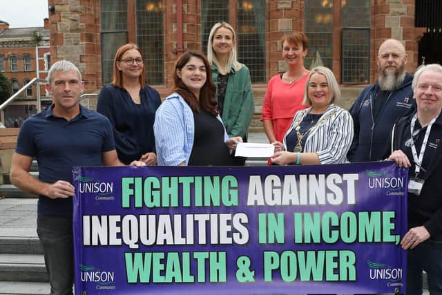 Saoirse Fanning, Unison NEC, handing over a cheque for £300 for the Mayor's Charity "First Housing", to Mayor Sandra Duffy. Unison members included, from left, Niall McCarroll, Elaine Hodgson, Eileen Nicholl, Alison Hamilton, Eamon McGeehan and Paul McCartney. (Photo - Tom Heaney, nwpresspics)