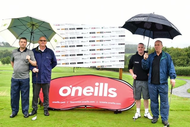 The umbrellas are out for this fourball as they get ready to tee off at the Edgar McCormick Golf Classic, which took place at Foyle Golf Centre, on Saturday.