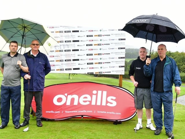 The umbrellas are out for this fourball as they get ready to tee off at the Edgar McCormick Golf Classic, which took place at Foyle Golf Centre, on Saturday.