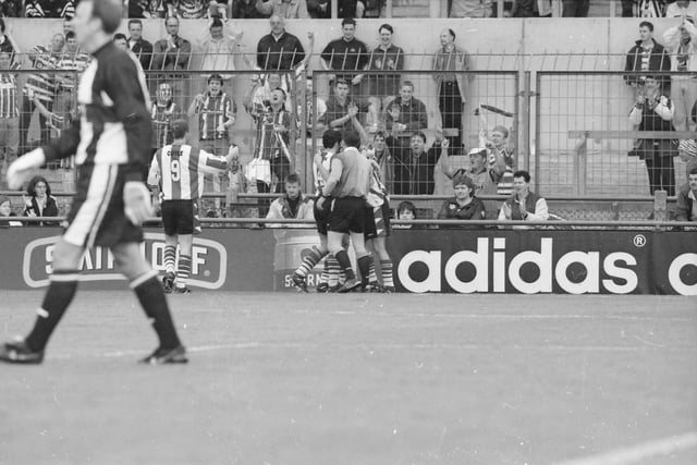 Derry players celebrate in front of their supporters after Celtic's Tom Boyd put the ball in his own net to make it 2-1 to city