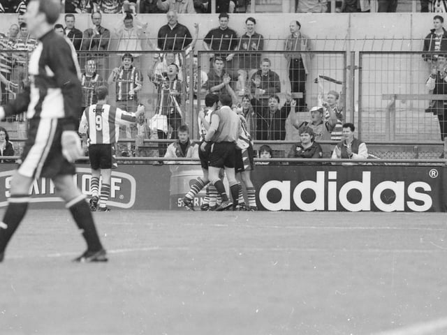 Derry players celebrate in front of their supporters after Celtic's Tom Boyd put the ball in his own net to make it 2-1 to city