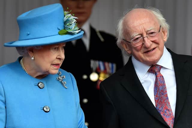 Queen Elizabeth II stands with Irish President Michael D. Higgins. Photo credit: BEN STANSALL/AFP via Getty Images