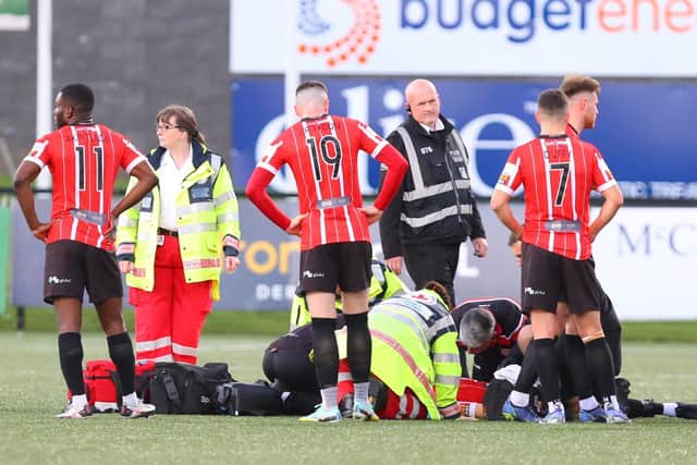 Derry City defender Ciaran Coll is treated on the pitch after falling awkwardly during the first half against Bohs.